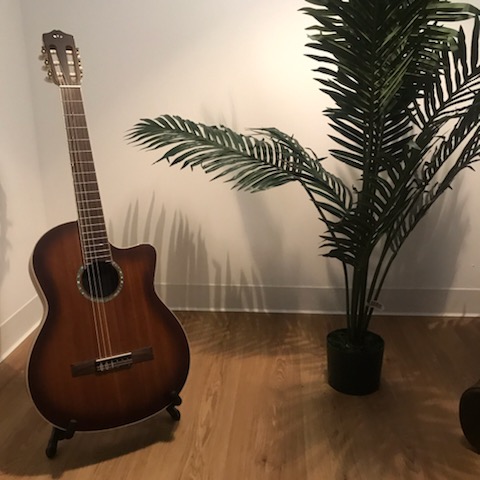 Acoustic guitar leaning in a cozy room