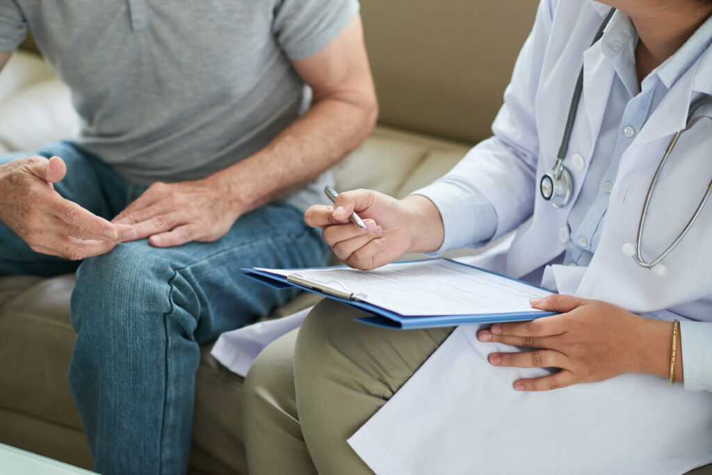 unrecognizable female doctor sitting couch with male patient