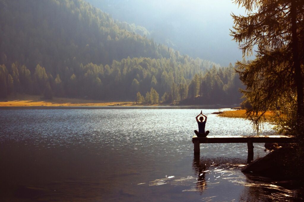 Fog drifting over a forested lake